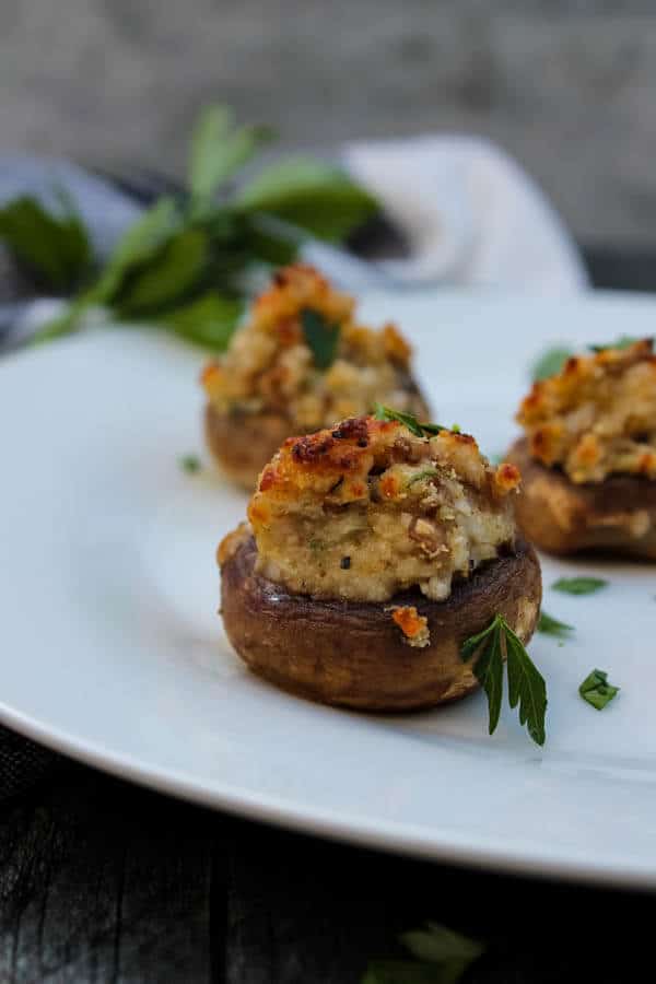 These Cheese-Stuffed Mushrooms are a long-time family favorite. Mushrooms are sauteed and then stuffed with Parmesan cheese, breadcrumbs, mushrooms and onions for a hearty, flavorful vegetarian appetizer that everyone will enjoy. 