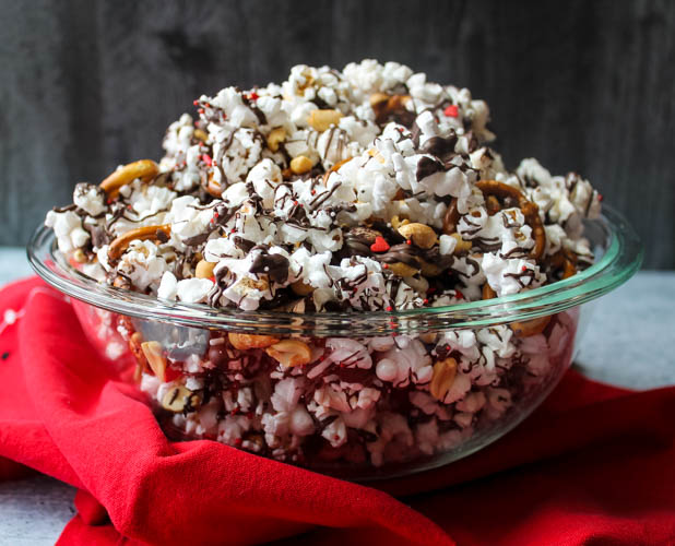 Sweet & Salty Valentine's Popcorn Mix - Salty popcorn, peanuts, and pretzels are drizzled with dark chocolate and topped with sprinkles for a Valentine's Day snack both adults and kids will love! 