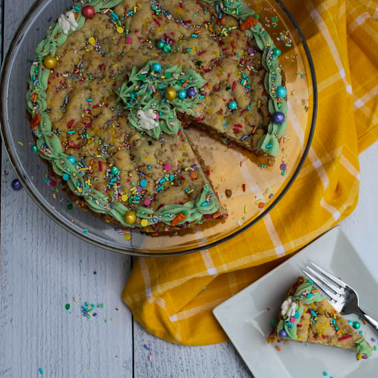 This Spring Sugar Cookie Cake is an easy sweet treat to bring a smile to faces this spring. Rich in vanilla flavor and topped with a bit of spring-colored frosting and festive sprinkles, this Spring Sugar Cookie Cake is simply irresistible. 