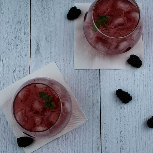 A make ahead cocktail to serve a crowd, this Blackberry Tequila Cooler combines sweet blackberries, tart lime, and bubbly wine for a light and refreshing summer cocktail.