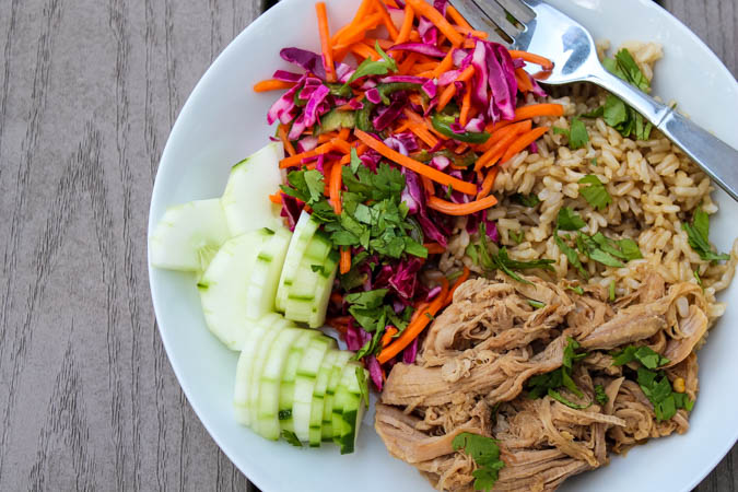 Sweet yet spicy pulled pork, quick pickled vegetables and hearty brown rice is my new favorite summer combo - Slow Cooker Pork Banh Mi Bowls with Pickled Vegetables. With bright flavors, you don't even need to turn on the oven to enjoy this satisfying meal! 