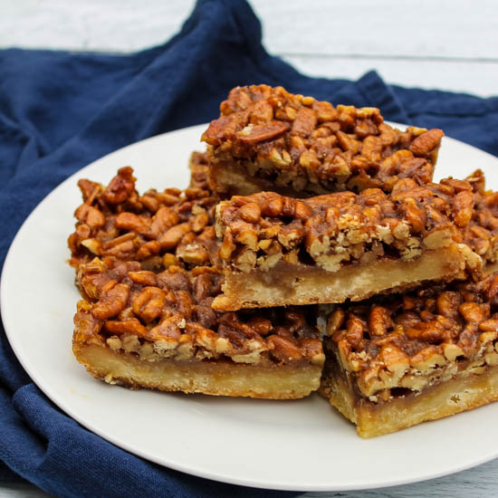 Shortbread topped with loads of sweet pecans have all the best flavors of pecan pie but served as a finger food perfect for fall and winter parties. Bonus: These Pecan Pie Bars make a ton and freeze beautifully, making it a great make ahead dessert for fall entertaining. 