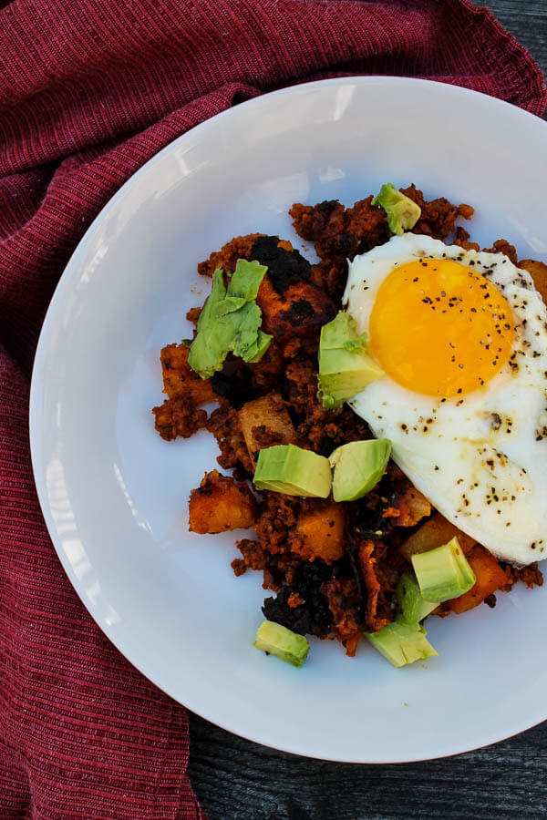 Chorizo Potato Hash is a tasty, indulgent dish of sauteed potatoes and Mexican chorizo, topped with a fried egg and fresh avocado. Enjoy as a hearty breakfast, flavorful brunch, or comforting breakfast for dinner.