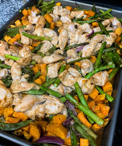 Sheet Pan Spicy Peanut Chicken & Veggies: Chicken, sweet potatoes and your choice of veggies are roasted on a sheet pan and then topped with a spicy peanut sauce and crunchy peanuts for a balanced, flavorful meal. 