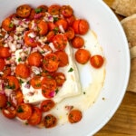 This Mediterranean Baked Feta is an irresistible, quick and easy summer appetizer. Pile salty feta with sweet cherry tomatoes and herbs and heat in the oven until warmed throughout. Easy peasy!