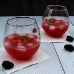 A make ahead cocktail to serve a crowd, this Blackberry Tequila Cooler combines sweet blackberries, tart lime, and bubbly wine for a light and refreshing summer cocktail.