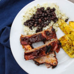 Slow-roasted baby back ribs are rubbed with a zesty spice mix and cook in the oven for hours, becoming nice and tender. The ribs are then finished on the grill with some barbecue sauce for a finger-licking delicious meal.