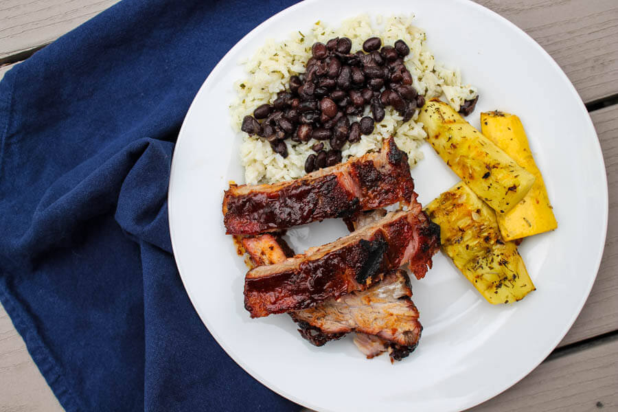 Slow-roasted baby back ribs are rubbed with a zesty spice mix and cook in the oven for hours, becoming nice and tender. The ribs are then finished on the grill with some barbecue sauce for a finger-licking delicious meal.