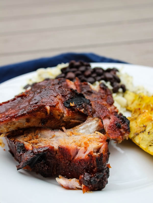 Slow-roasted baby back ribs are rubbed with a zesty spice mix and cook in the oven for hours, becoming nice and tender. The ribs are then finished on the grill with some barbecue sauce for a finger-licking delicious meal.