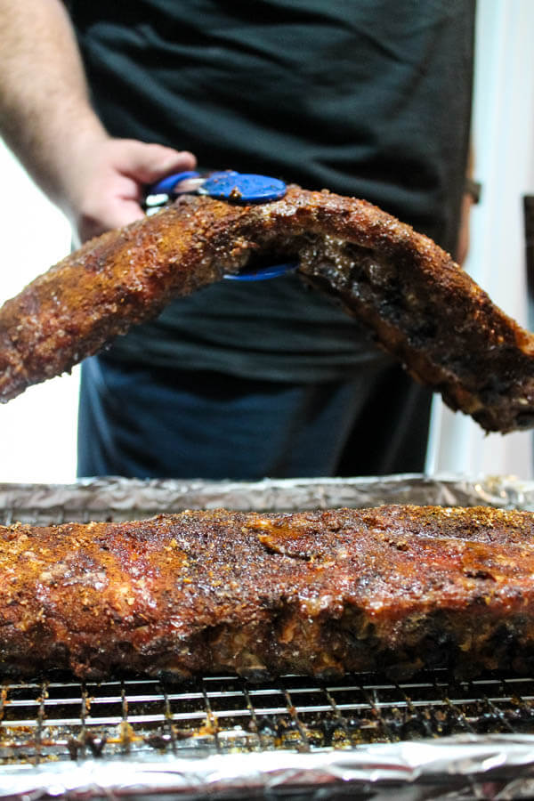 Slow-roasted baby back ribs are rubbed with a zesty spice mix and cook in the oven for hours, becoming nice and tender. The ribs are then finished on the grill with some barbecue sauce for a finger-licking delicious meal.