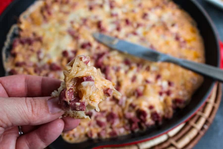 This Hot Reuben Dip tastes just like the sandwich. Corned beef, sauerkraut, Thousand Island dressing and Swiss cheese are mixed together and served piping hot - in a hearty dip great for fall and winter entertaining and game days. 