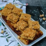 These Coconut Macadamia Nut Bars are an unexpected, bar cookie - a shortbread crust topped with a sweet and salty mix of coconut and macadamia nuts.