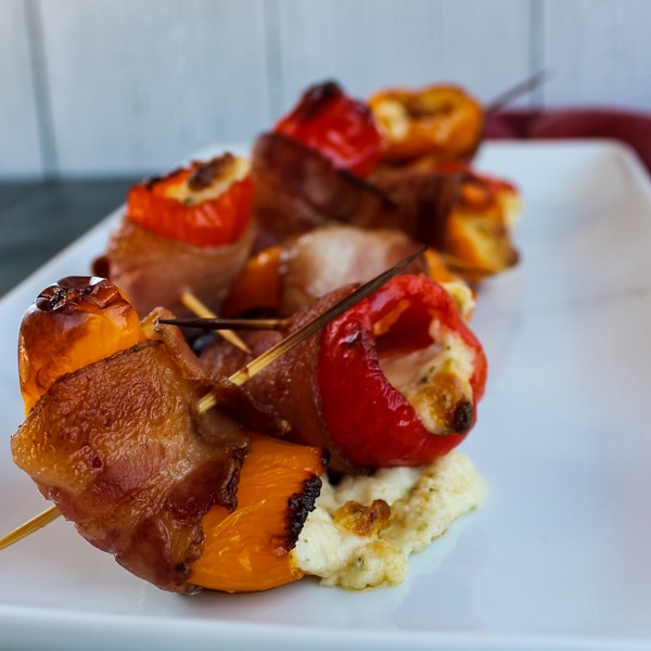 These Bacon-Wrapped Cheese-Stuffed Baby Bell Peppers were an irresistible little appetizer! Sweet baby bell peppers are stuffed with herbs and Italian cheeses and wrapped in applewood smoked bacon for a light but decadent feeling appetizer or snack.