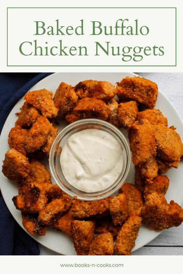 Overhead view of a baked buffalo chicken nuggets on a plate surrounding a bowl of blue cheese dressing, for dipping.