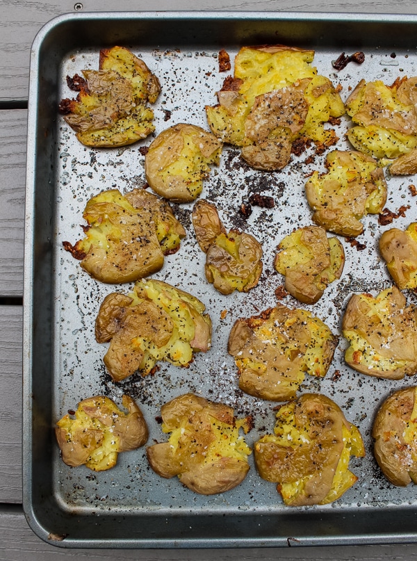 Crispy smashed dutch potatoes on a baking sheet, fresh from the oven.