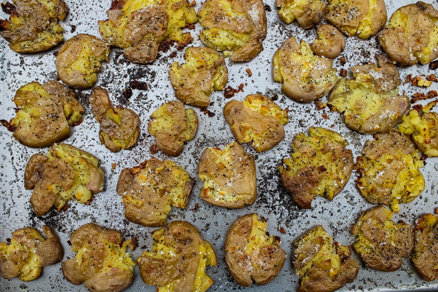 Crispy smashed dutch potatoes on a baking sheet, fresh from the oven.