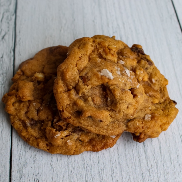 Overhead shot of two Salted Butterscotch Pretzel Cookies on a white background