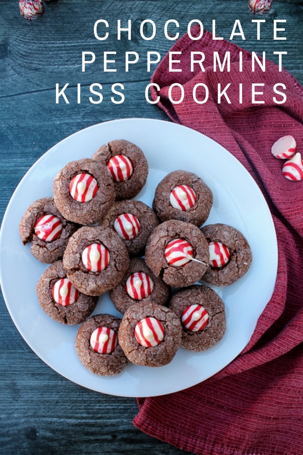 A sweet peppermint Hershey kiss - a candy cane kiss - gives a holiday flair to a soft chocolate cookie in these Chocolate Peppermint Kiss Cookies.