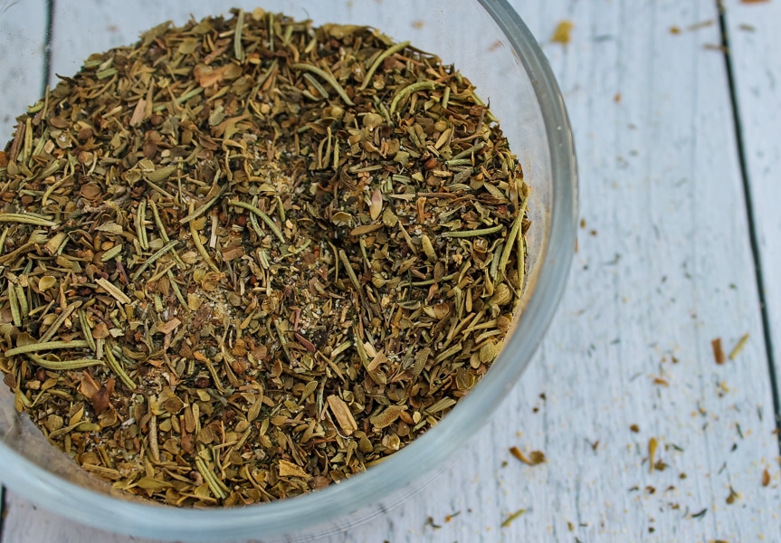 overhead view of a clear bowl of Greek Seasoning Spice Blend set against a white background