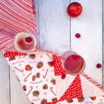 Overhead view, two glasses of Poinsettia Champagne Cocktail and a red Christmas ornament