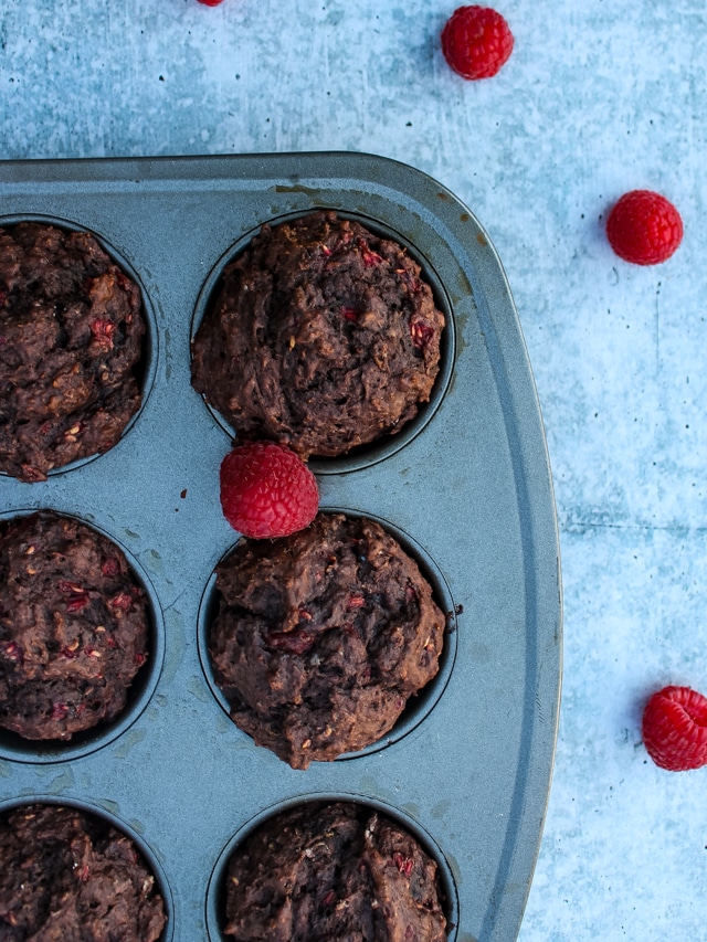 overhead shot of chocolate raspberry muffins in a muffin pan