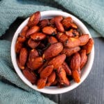 overhead view of honey & rosemary almonds in a small white bowl