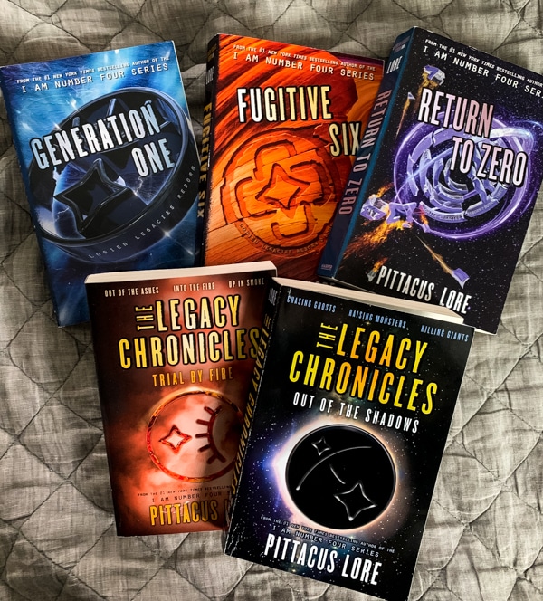 overhead view of the books in the Lorien Legacies: Reborn and The Legacy Chronicles series