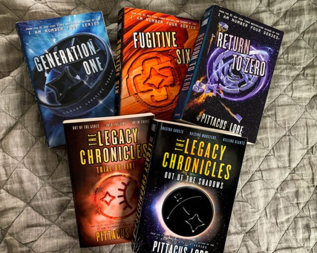 overhead view of the books in the Lorien Legacies: Reborn and The Legacy Chronicles series