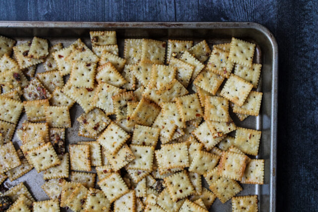 overhead view of a baking sheet of spicy seasoned crackers