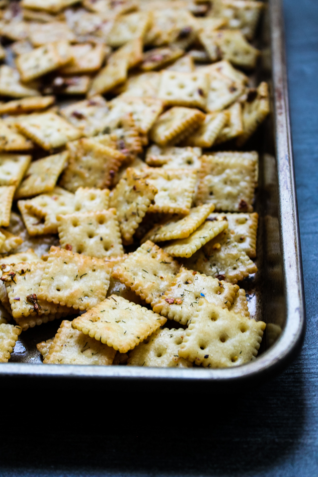 spicy seasoned crackers on a baking sheet