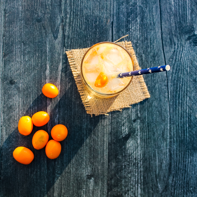 overhead view of St. Germain Kumquat Cocktail with kumquats