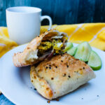 side view of Everything-but-the-Bagel Breakfast Pockets broken in half on a plate