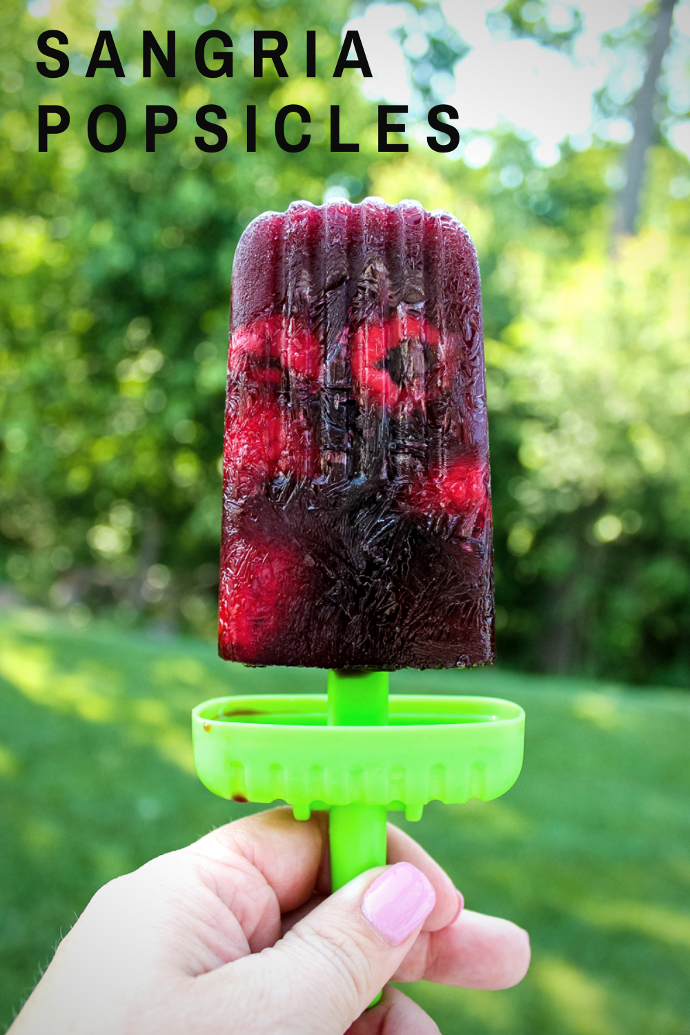 Sangria Popsicles - popsicles of wine, juice and fruit - are light, refreshing, and just a bit boozy. And a fun way to cool off on a hot summer afternoon!