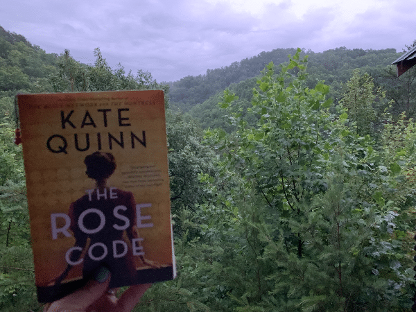 the Rose Code by Kate Quinn, with a backdrop of the mountains