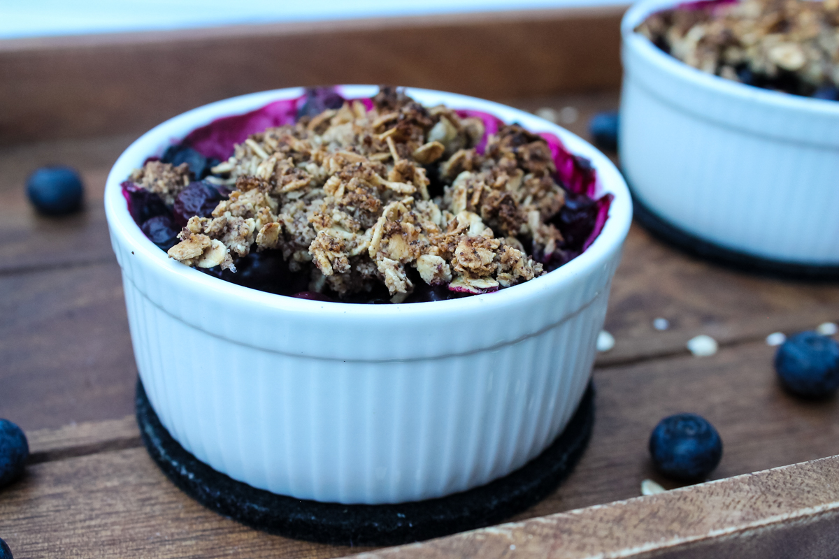 White ramekin of Blueberry Crisp with a crumble topping