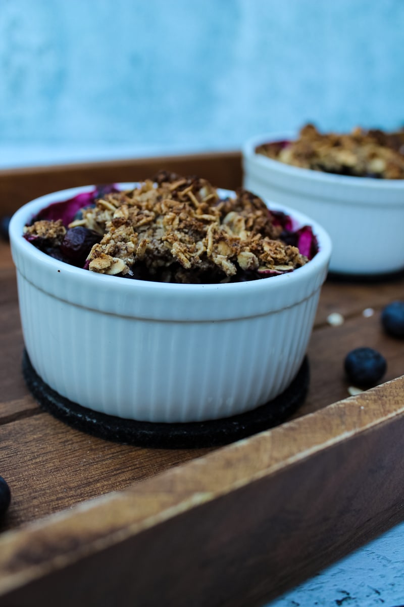 White ramekin of Blueberry Crisp with a crumble topping