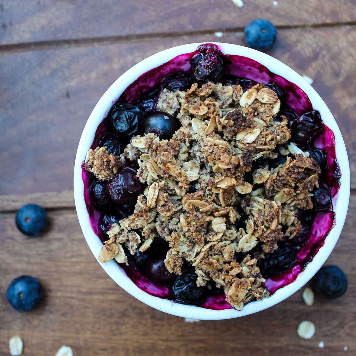 White ramekin of Blueberry Crisp with a crumble topping