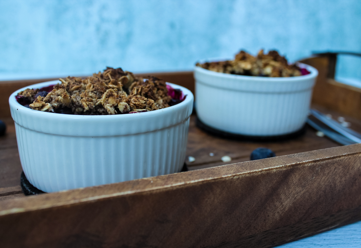 White ramekin of Blueberry Crisp with a crumble topping