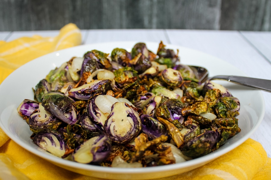 side view of a bowl of Air Fryer “Roasted” Brussels Sprouts