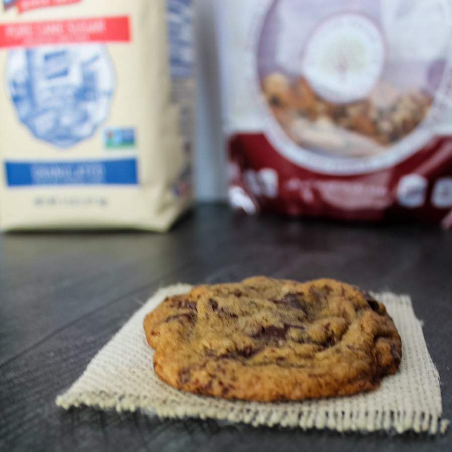 a Espresso Chocolate Chip Cookie with a bag of Dixie Crystals sugar and Millican Pecans